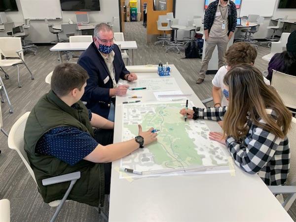 Civic Leadership Academy students work side by side with the City of Olathe Deputy Director of Parks and Recreation learning how to use design and measurement tools to plan Loula Park off of 135th street in Olathe.  